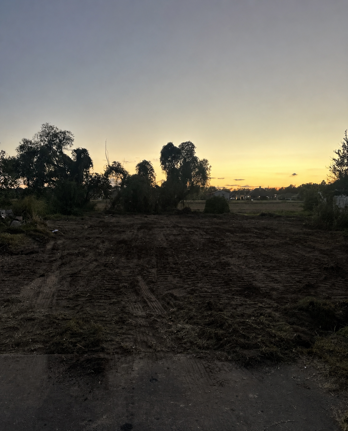 Same lot cleared and graded at sunset after demolition