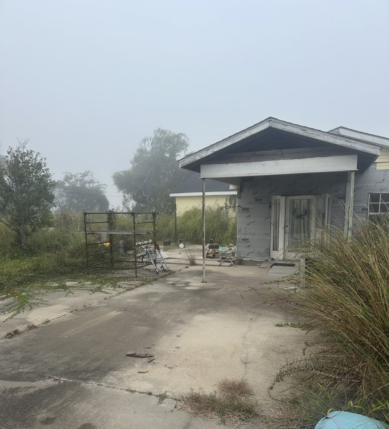 House and overgrown lot before Voodoo Disposal demolition